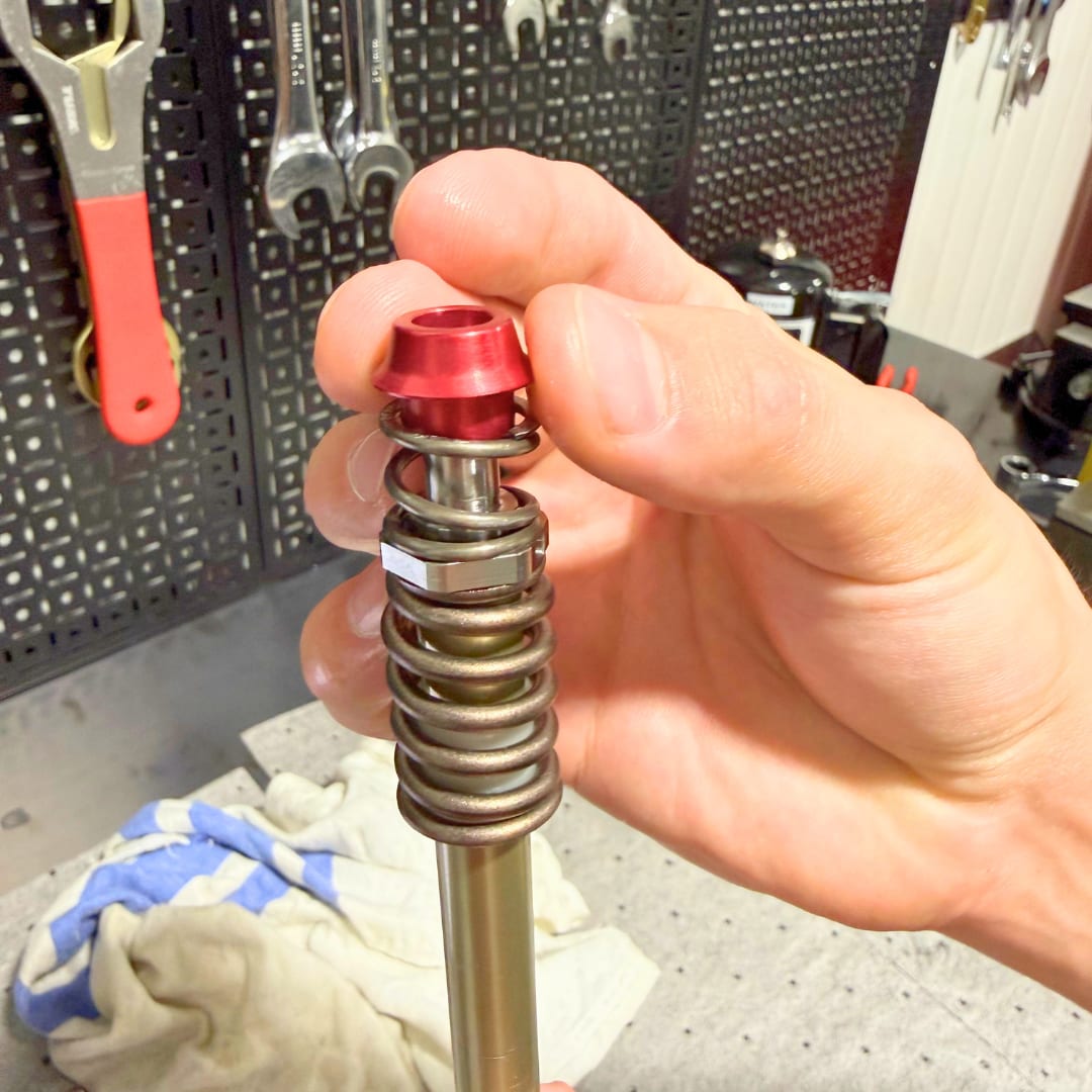 Cone sliding onto the TAP shaft, nose up toward the piston