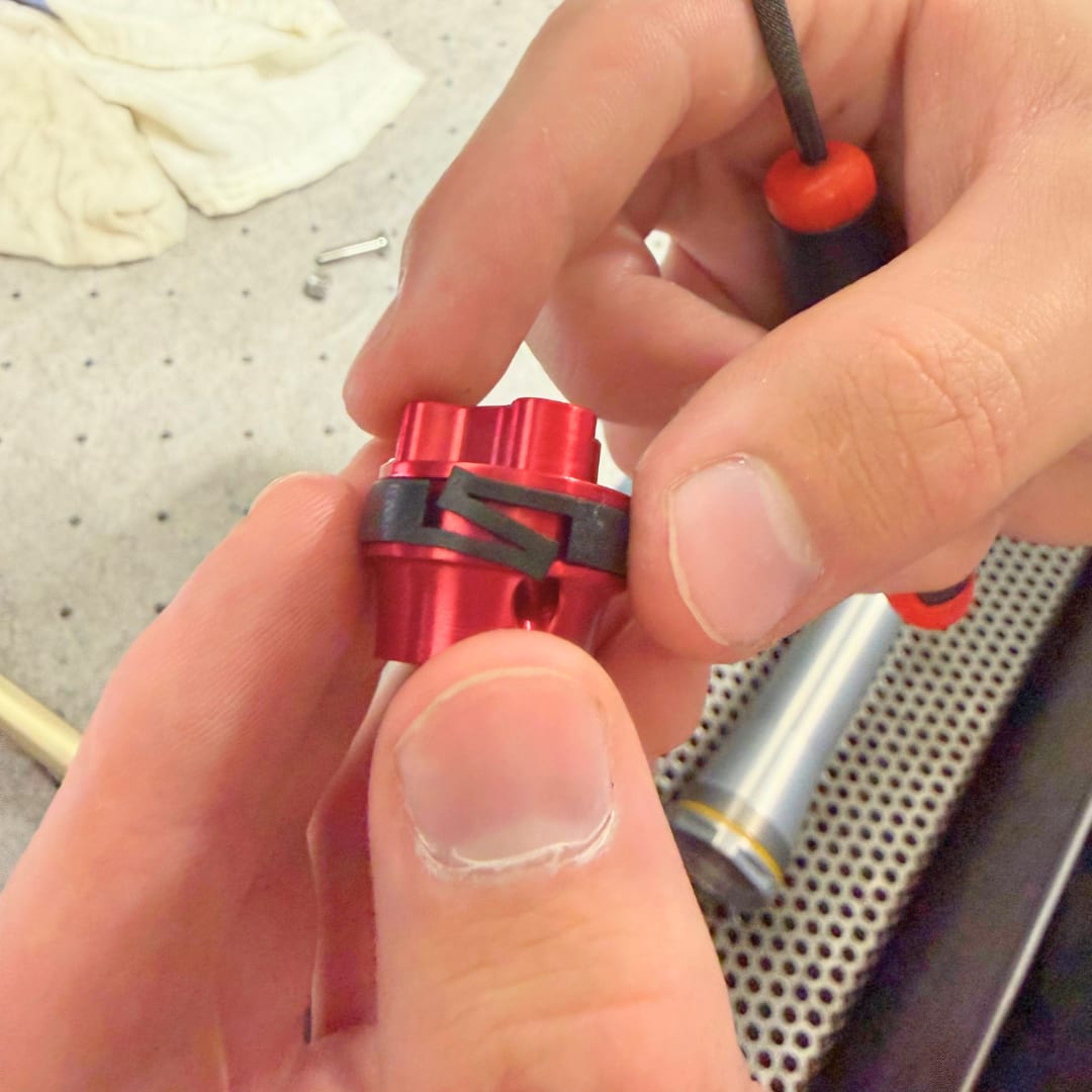 Piston friction band seated in its groove