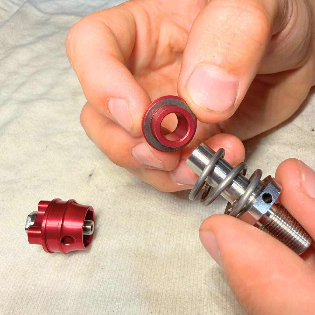 Cone and spacer shim going back onto the TAP shaft above the spring